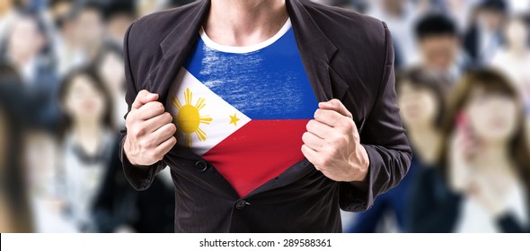 Businessman stretching suit with Philippines Flag with a crowd people on background