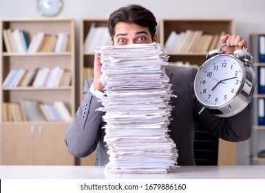 Businessman struggling to meet challenging deadlines - Shutterstock ID 1679886160