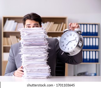 Businessman struggling to meet challenging deadlines - Shutterstock ID 1701103645