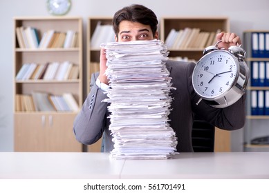 Businessman struggling to meet challenging deadlines - Shutterstock ID 561701491