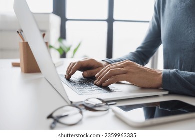 Businessman or student using laptop at office, Man hands typing on computer keyboard closeup