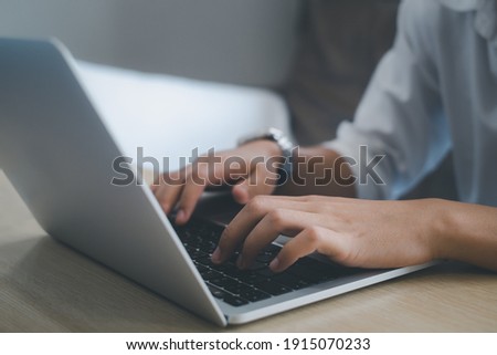Businessman or student wearing white shirt using laptop for searching, working, online learning, marketing, studying, distance education network online technology background.selective focus.
