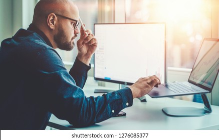 Businessman study financial market to calculate possible risks and profits. Male economist accounting money and research statistics graphs on laptop computer at office desktop. Quotations on exchange - Shutterstock ID 1276085377