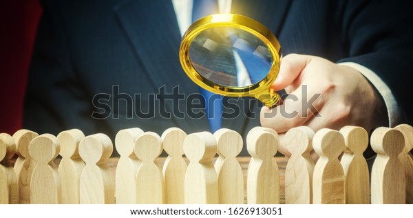 Businessman is studying a crowd of people with\
a magnifying glass. Hr search candidates for work, staff\
recruiting. Society, demographic. Market and customers research.\
Citizens electorate.\
Sociology