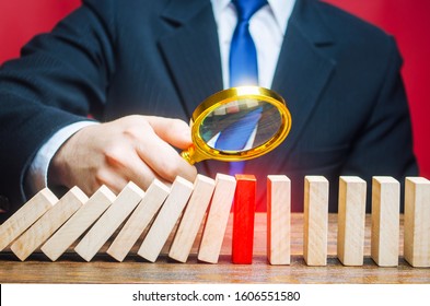 A businessman is studying the reason for stopping the fall of dominoes. Find the stop reason the work process. Error or failures, force majeure. Elimination of obstacles malfunctions, analysis - Shutterstock ID 1606551580
