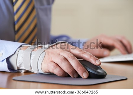 Businessman Suffering From Repetitive Strain Injury (RSI)