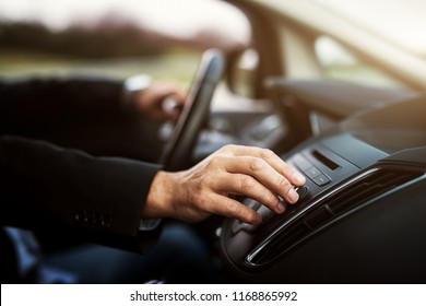 Businessman In Suit Is Adjusting A Volume On His Stereo While Driving A Car.