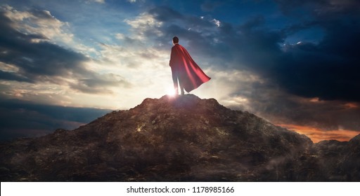 Businessman in a suit and cape hero on top of a mountain,Business Success concept. - Shutterstock ID 1178985166