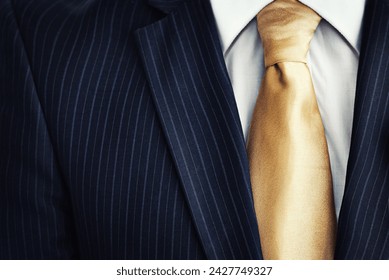 Businessman, suit and gold tie in fashion for corporate style, attire or clothing with jacket, lines or pattern. Closeup of man, worker or employee in stylish shirt of neat professional with necktie - Powered by Shutterstock