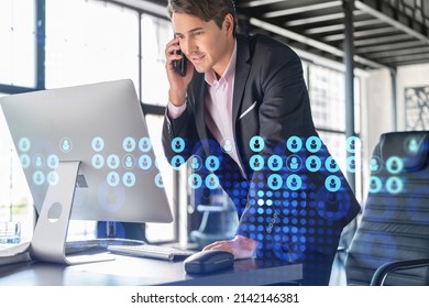 Businessman in suit has conference call to hire new employees for international business consulting. HR, social media hologram icons and interconnections over office background with panoramic windows - Shutterstock ID 2142146381