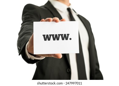 Businessman in a suit holding up a business card with www sign. Isolated over white.