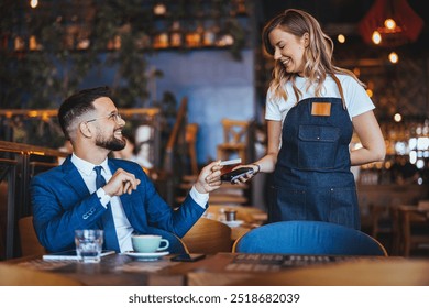 A businessman in a suit joyfully interacting with a waitress while holding a credit card and paying at a cozy cafe. The atmosphere is warm and welcoming. - Powered by Shutterstock