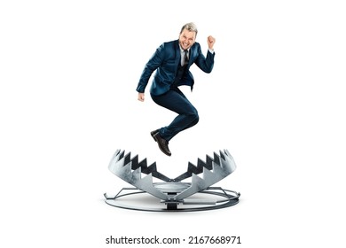 A businessman in a suit jumps into a large metal bear trap. Concept of problem solving, failure, crisis, mixed media