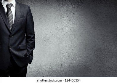 businessman in suit on a concrete background - Powered by Shutterstock