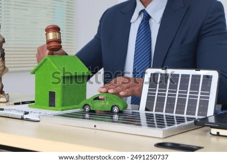 A businessman in a suit sits at a table discussing the Clean Energy Act, which incentivizes renewable energy adoption, clean raw material use in energy production, and energy-efficient transportation.