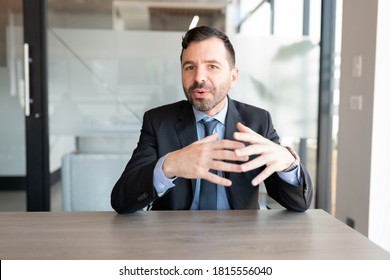 Businessman In Suit Talking To Camera During A Web Conference In Office