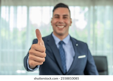 A businessman in a suit and tie giving a thumbs up. - Powered by Shutterstock