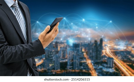 A businessman in a suit and tie holds a smartphone in front of a city skyline at dusk. - Powered by Shutterstock