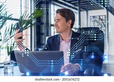 Businessman In Suit Using Smart Phone To Optimize Development By Implying New Technologies In Business Process. Interconnections And Hi Tech Hologram Over Modern Panoramic Office Background.