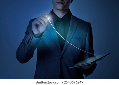 Businessman in a suit using a tablet, drawing a glowing business line. Technology, innovation, and digital growth graph concept. Professional and futuristic business setting. Business graph overlay. - Powered by Shutterstock