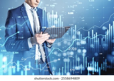 Businessman in suit using tablet with financial graphs overlay, blue background, concept of global trading, stock market, and growth - Powered by Shutterstock - Get 15% off with code: PIKWIZARD15