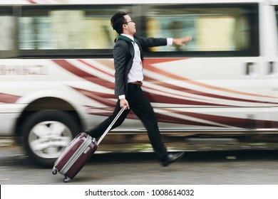 Businessman With Suitcase Running To Catch The Bus