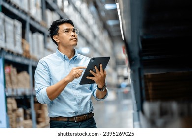 Businessman or supervisor uses a digital tablet to check the stock inventory in furniture large warehouses, a Smart warehouse management system, supply chain and logistic network technology concept. - Powered by Shutterstock