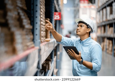 Businessman or supervisor uses a digital tablet to check the stock inventory in furniture large warehouses, a Smart warehouse management system, supply chain and logistic network technology concept. - Powered by Shutterstock