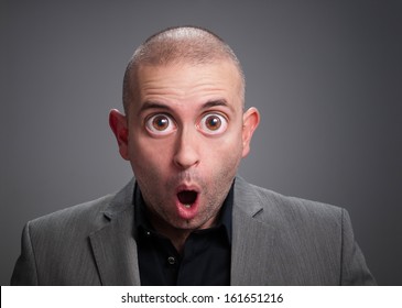 Businessman With Surprise Expression. The Photo Has A Digital Retouching With Eyes Wide Open