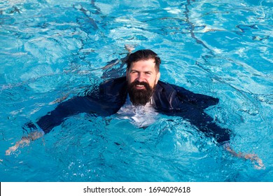 Businessman swimming in suit in the pool. Funny and crazy man in swimming Pool. Business Man having fun by the Pool - Powered by Shutterstock