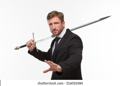 Businessman with sword showing his palm isolated on white background. Serious man in business suit going to stop corruption in his company.