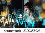 Businessman, tablet and dashboard at night of stock market, trading or graph and chart data at office. Man trader or broker working late on technology checking digital trends, analytics or statistics