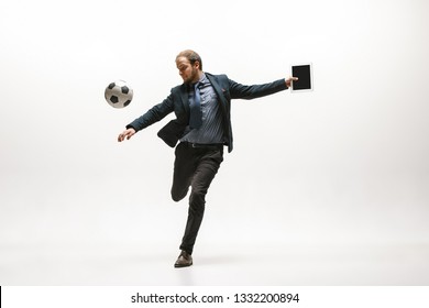 Businessman With Tablet And Football Ball In Office. Soccer Freestyle. Concept Of Balance And Agility In Business. Manager Perfoming Tricks Isolated On White Studio Background.