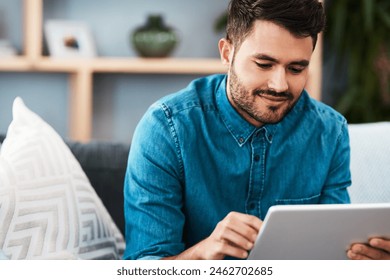 Businessman, tablet and happy working from home for remote job, internet search or social media. Male person, smile and confident on sofa with technology for graphic design or online communication - Powered by Shutterstock