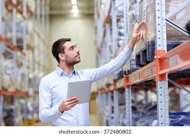 businessman with tablet pc at warehouse