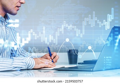 Businessman take note in business notebook, laptop with coffee on desk. Double exposure with rising bar chart and lines. Concept of financial analysis and worldwide trading
