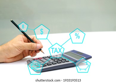 Businessman Takes Or Holding A Pencil And Calculates Taxes Of Property Or Real Estate Or Saving With A Calculator.