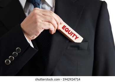 Businessman Takes Out A Wooden Block From His Pocket With The Word Equity. Financial Or Workplace Equity Concept.

