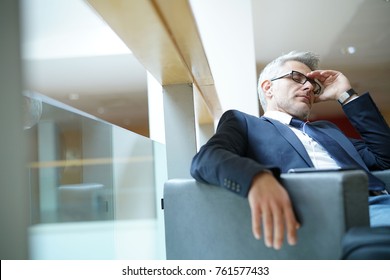 Businessman taking a nap in airport departure lounge - Shutterstock ID 761577433