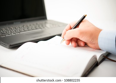 Businessman Taking Notes And Planning In A Meeting