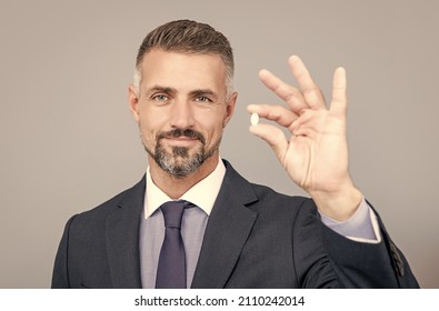 businessman taking pill. drug business. medical investment. entrepreneur presenting energy remedy. - Powered by Shutterstock