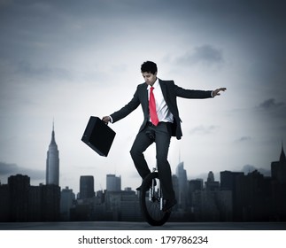 Businessman Taking A Risk On Unicycle In New York City