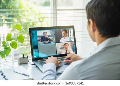 Uomo d'affari che parla con i suoi colleghi del piano in videoconferenza. Business team multietnico che utilizza laptop per una riunione online in videochiamata. 