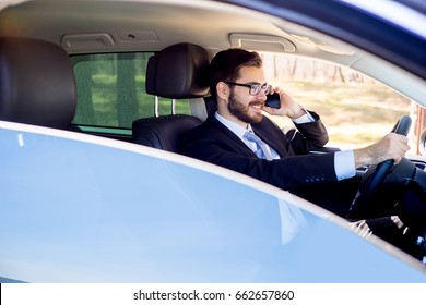 Businessman Talking On A Cell Phone In A Car