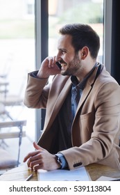 Businessman talking on Phone in Coffee Shop