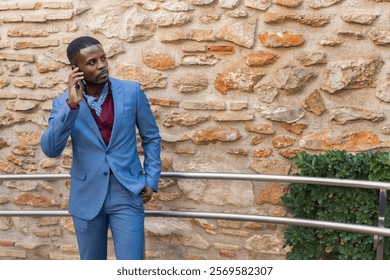 Businessman Talking on Phone in front of Stone Wall - Powered by Shutterstock