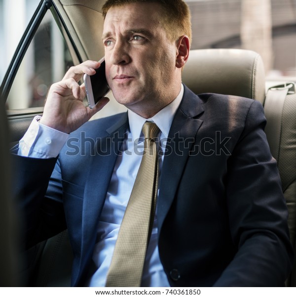 Businessman talking\
with someone on the\
phone