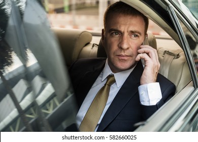 Businessman Talking Using Phone Car Inside