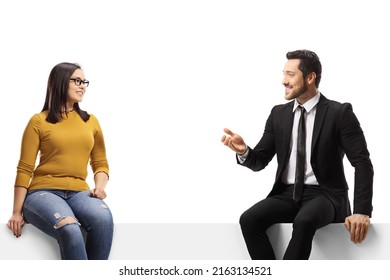 Businessman Talking To A Young Casual Female And Sitting On A Panel Isolated On White Background