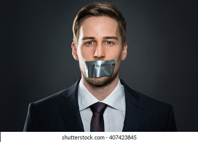 Businessman With Tape On His Mouth